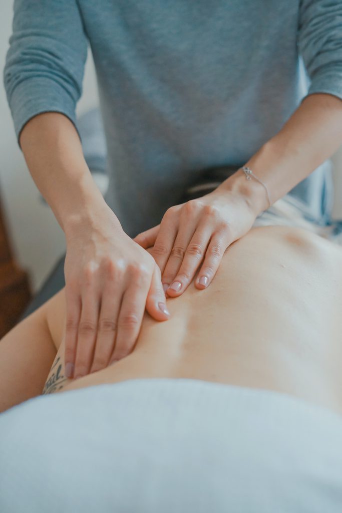 Hands on body performing sports massage